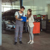 Mechanic and customer talking together at the repair garage