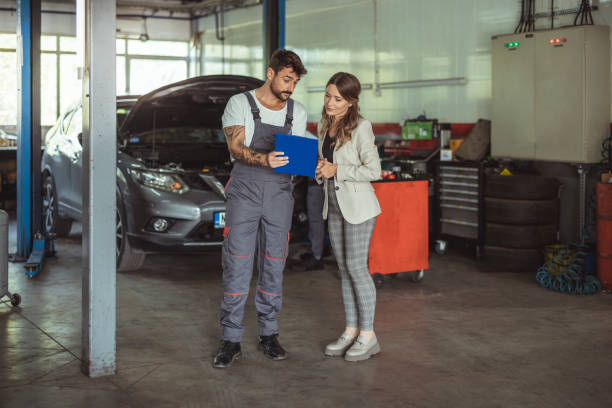 Mechanic and customer talking together at the repair garage